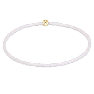 small white bead bracelet with one gold bead
