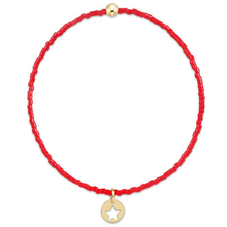 red beaded bracelet with small gold star disc charm