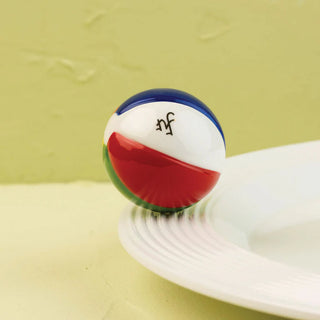 Colorful ball with a logo on a white surface against a green background