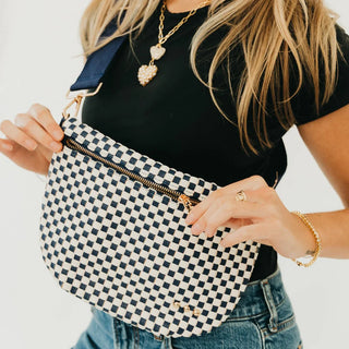 navy and cream leather bag in a woven pattern with gold zipper and navy strap