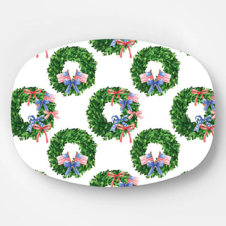 white melamine platter with boxwood wreaths with patriotic bows on the wreaths
