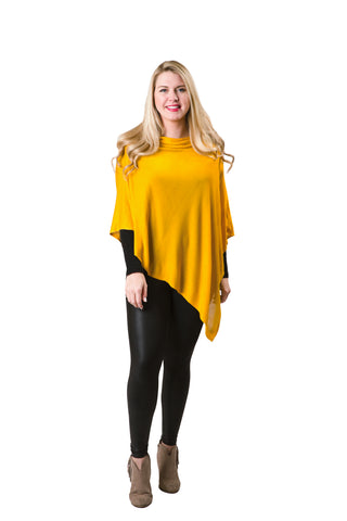 A woman wearing a yellow bamboo poncho with a geometric pattern, posing against a white background.